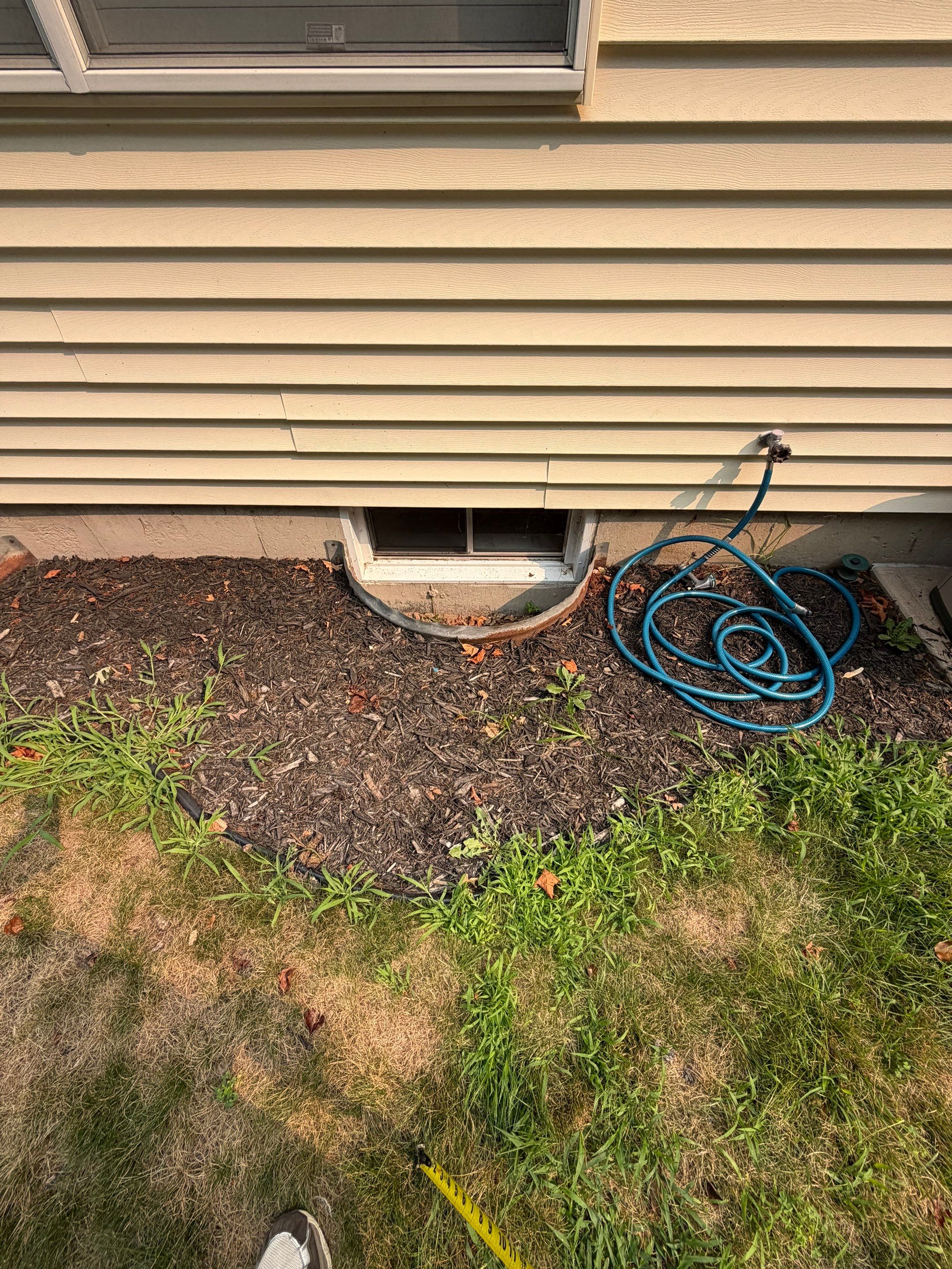 Before egress window installation in Bristol, Connecticut — exterior view