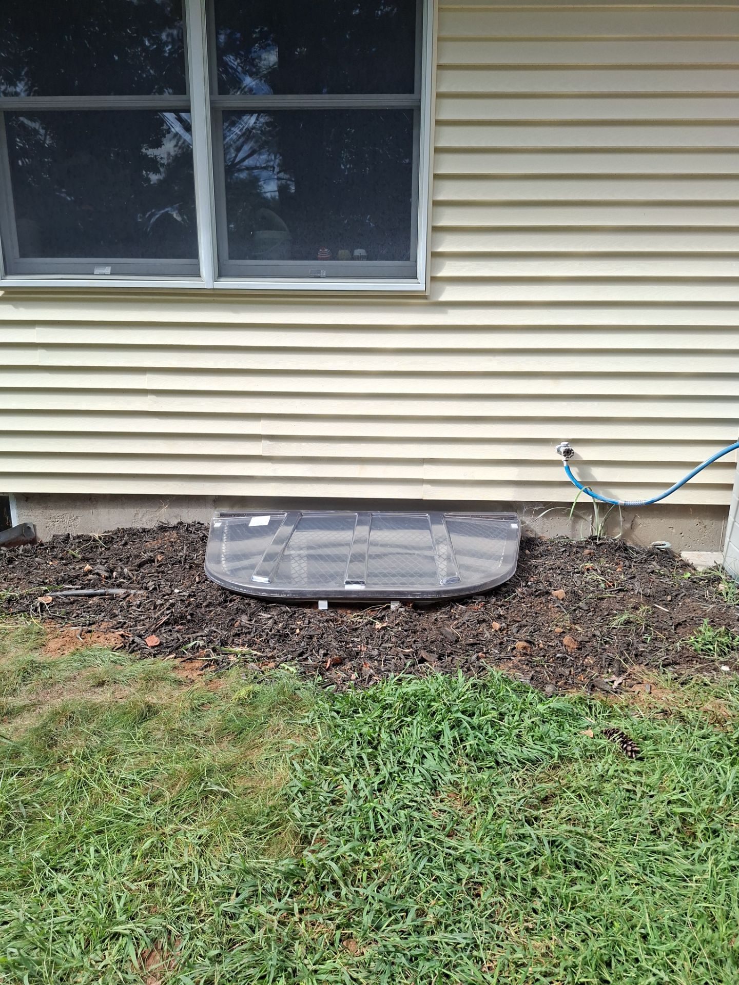 After egress window installation in Bristol, Connecticut — exterior view
