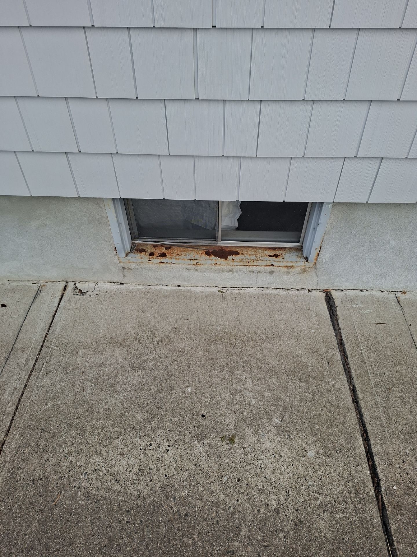 Before egress window installation in Bridgeport, Connecticut — exterior view
