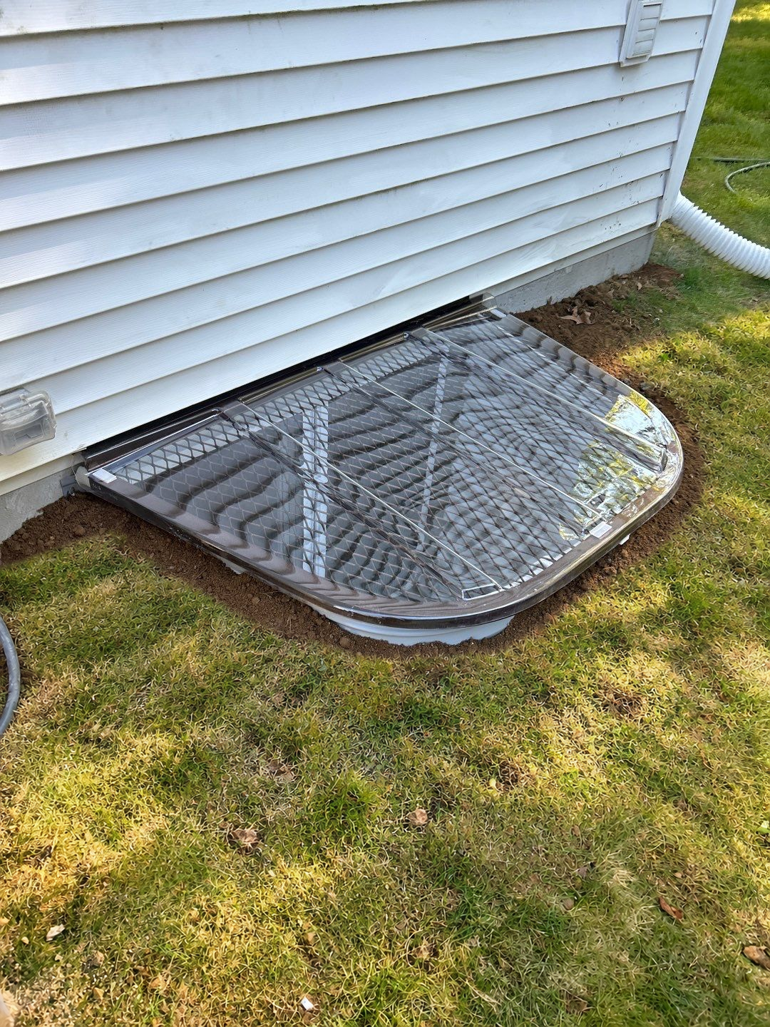 After egress window installation in East Lyme, Connecticut — exterior view