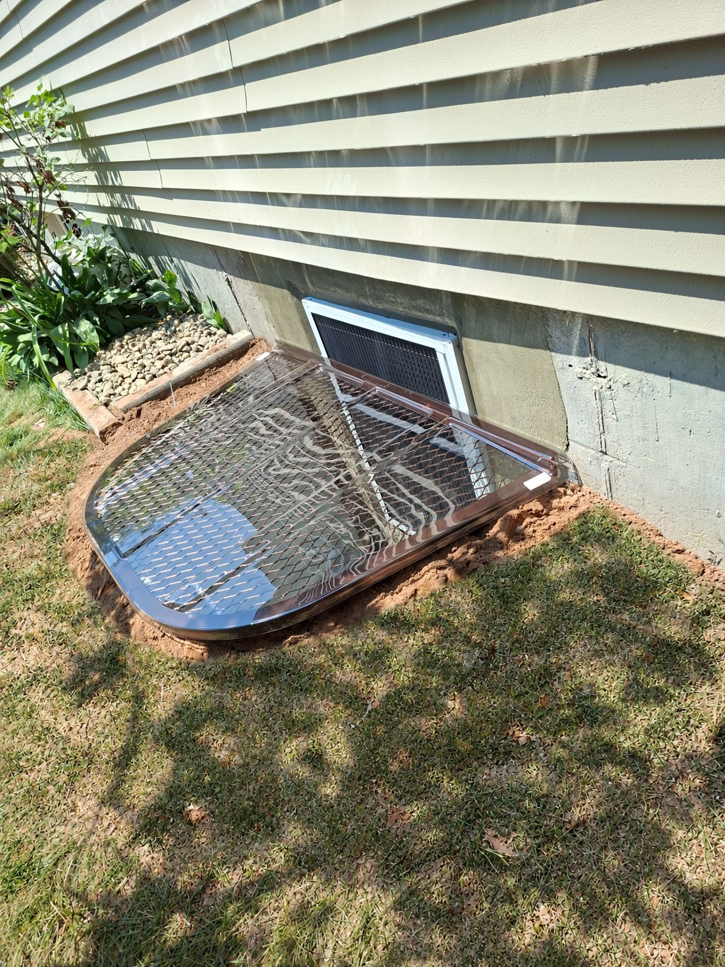 After egress window installation in Glastonbury, Connecticut — exterior view